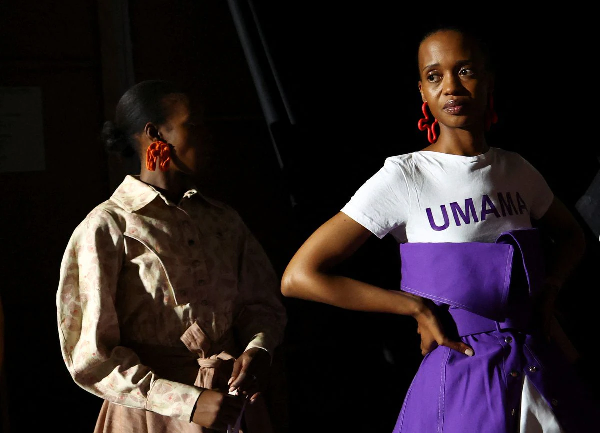 Models presenting creations by MUNKUS wait in the backstage during the second day of the South African Fashion Week (SAFW), at the Mall of Africa in Johannesburg, South Africa, October 21, 2022.