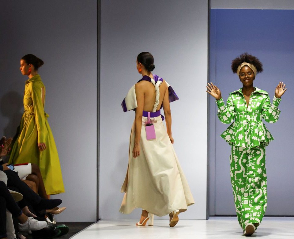 Thando Ntuli, winner of the SAFW 2022 Young Talent award and owner of MUNKUS, a womenswear label, acknowldges guests after models presented her creations during the second day of the South African Fashion Week (SAFW), at the Mall of Africa in Johannesburg, South Africa, October 21, 2022.