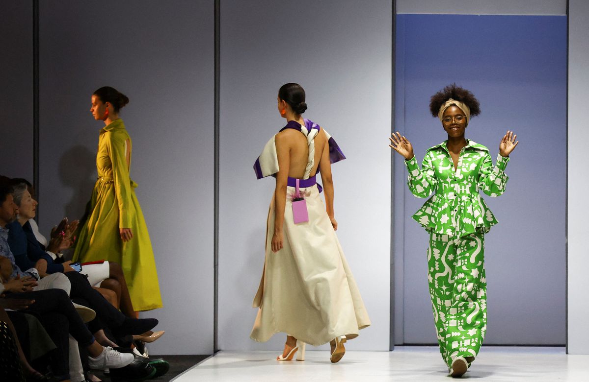 Thando Ntuli, winner of the SAFW 2022 Young Talent award and owner of MUNKUS, a womenswear label, acknowldges guests after models presented her creations during the second day of the South African Fashion Week (SAFW), at the Mall of Africa in Johannesburg, South Africa, October 21, 2022.