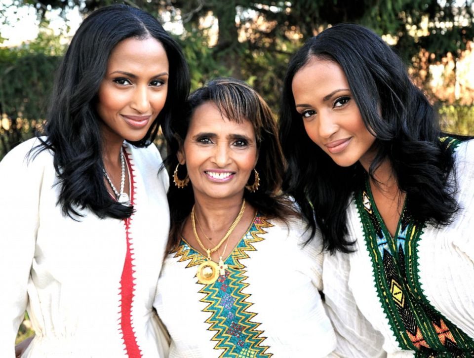 Feven Yohannes (left) and Helena Yohannes (right) with their mother, Nigisti, who inspired their lipstick color "Red Sea."