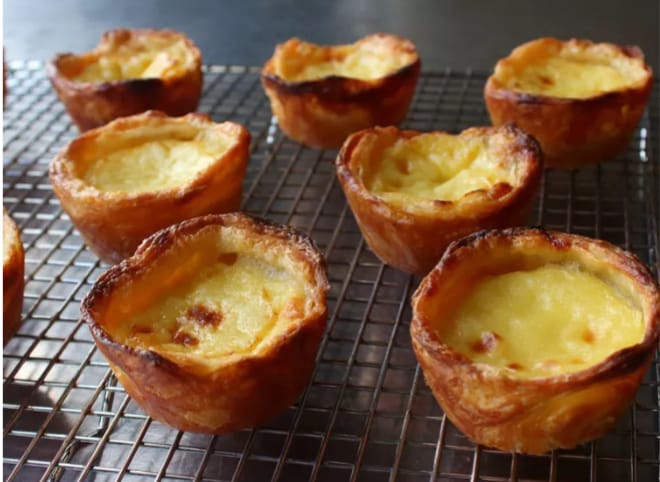 Treat yourself to a taste of Portugal with Pasteis de Nata - crispy, creamy custard tarts that melt in your mouth