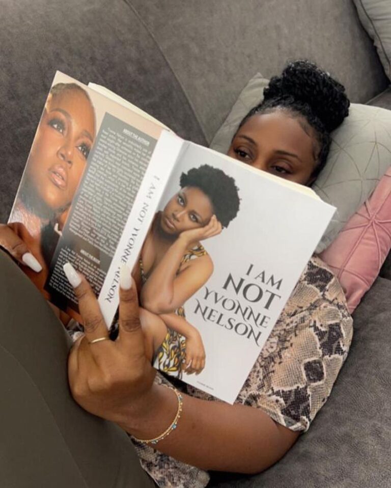 A woman reading "I Am Not Yvonne Nelson", written by Yvonne Nelson. Photo Credit: Yvonne Nelson/Instagram
