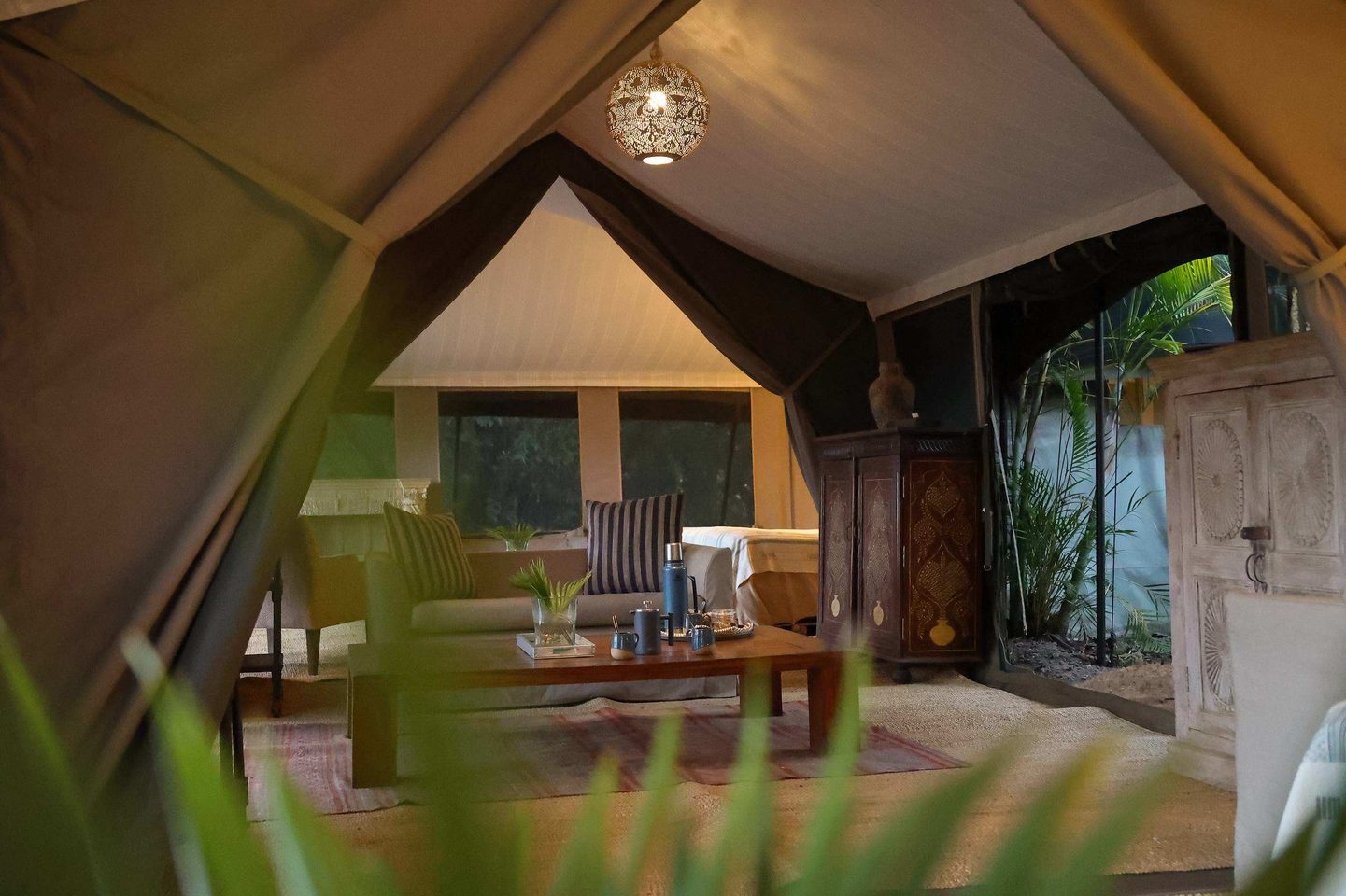 Tented Suite Interior: The meticulous interior refresh at River Camp Mara blends heritage charm with modern luxury. This view of the tented lounge shows the new tactile design vocabulary, featuring bespoke Nairobi-printed textiles and handcrafted elements from local Mara artisans. Photo Credit: Hemingways Collection