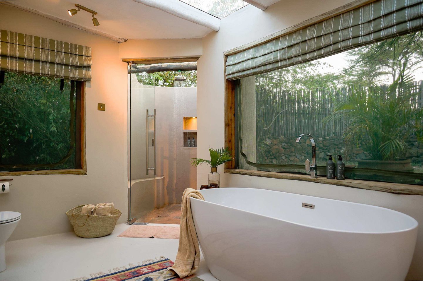 En-suite Bathroom: The upgraded en-suite bathrooms at River Camp Mara combine luxury standards with a connection to nature. This space features high-end fixtures alongside sustainable infrastructure upgrades, such as new solar water heating systems. Photo Credit: Hemingways Collection